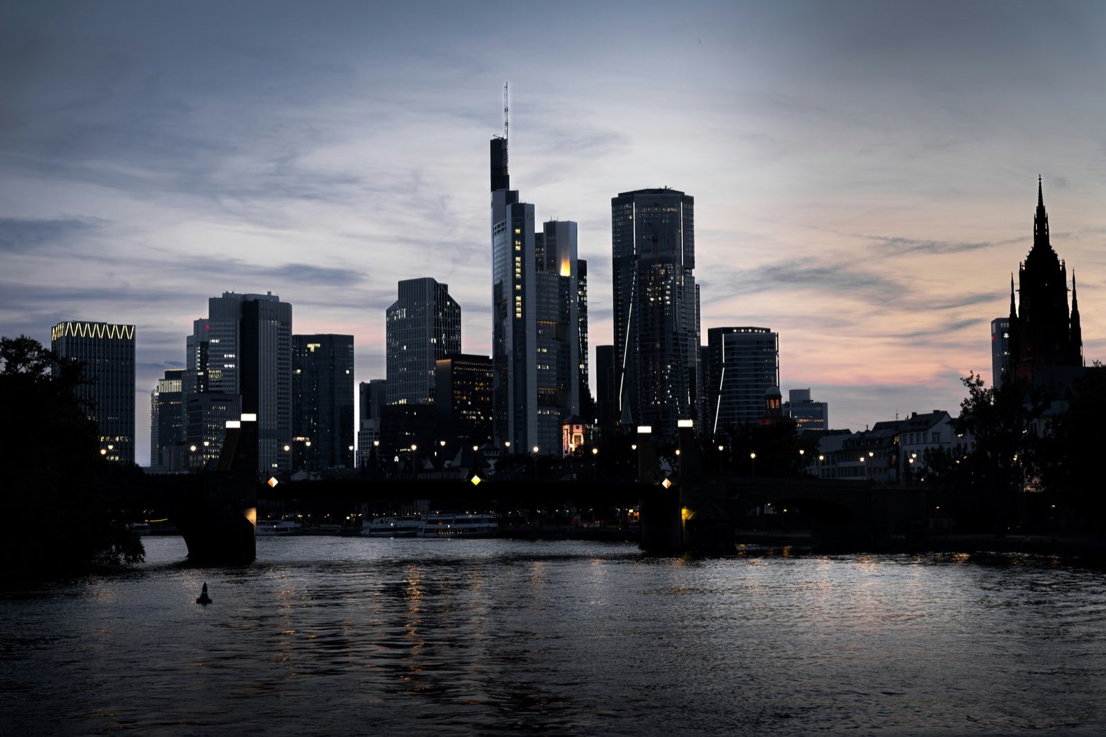A city skyline in silhouette at dusk