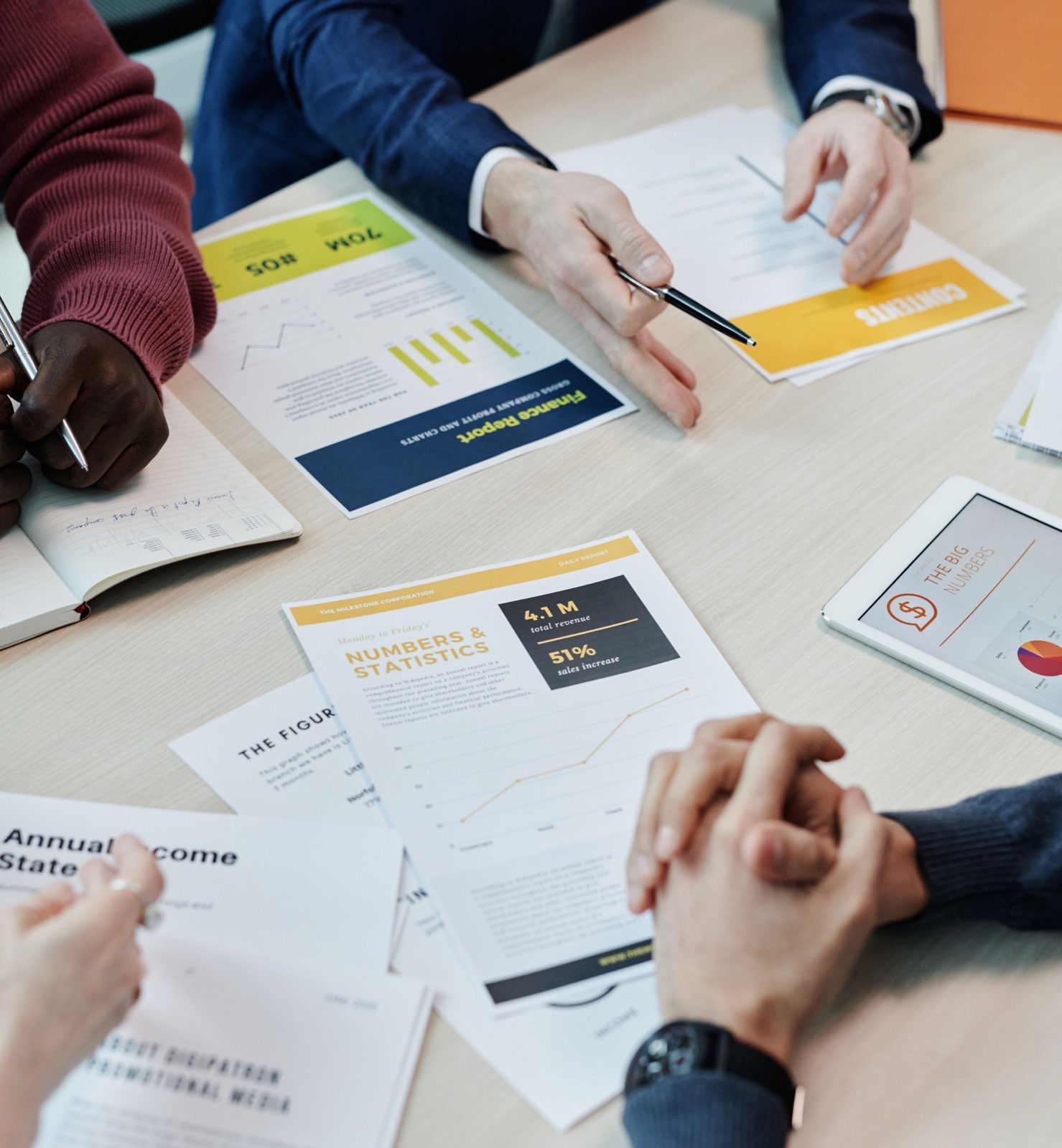 Financial reports and cash-flow plans laid out across a meeting table